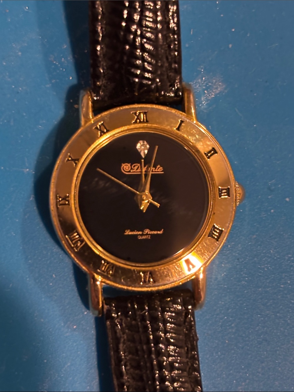 Gold-Tone Watch with Black Dial and Black Strap